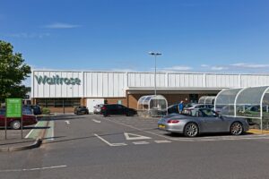 The John Lewis Partnership has struck a £500m deal with the investment firm Abrdn to build 1,000 residential rental homes, redeveloping three sites already owned by its Waitrose and eponymous retail store chains.